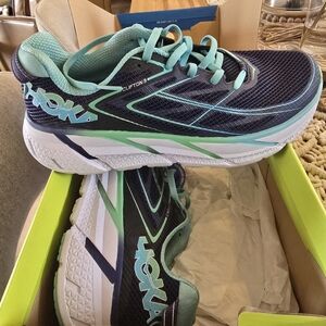 Hoka navy and mint green Clifton athletic shoes
